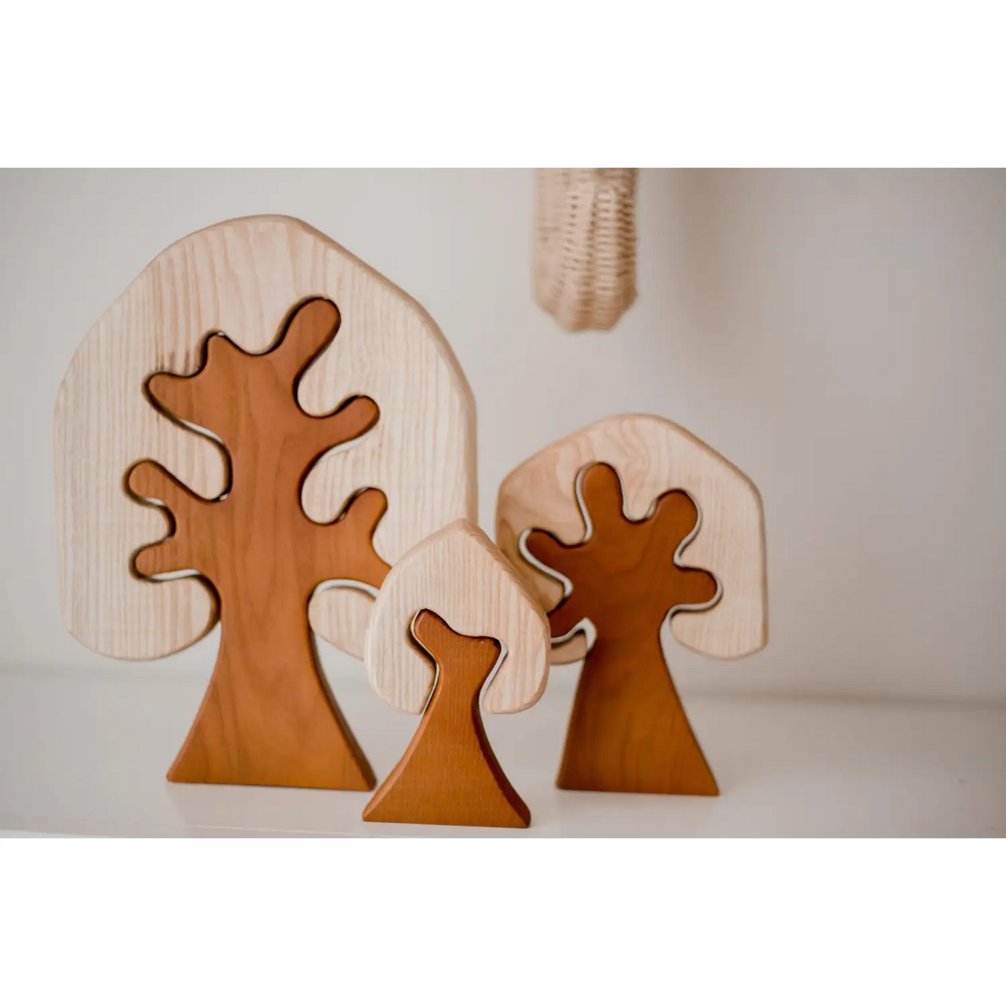 Wooden tree-shaped decorative objects with curved branches.