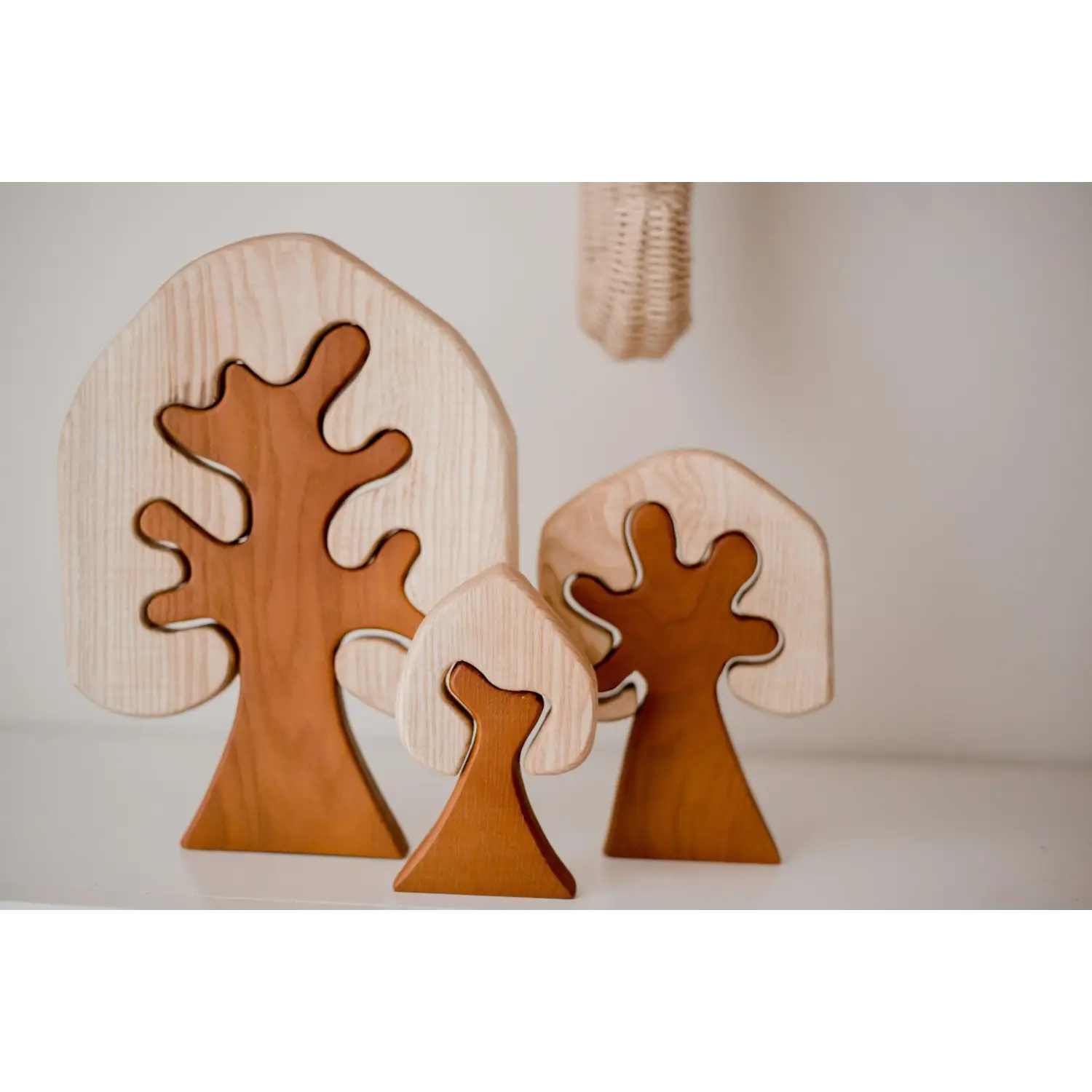 Wooden tree-shaped decorative objects with curved branches.