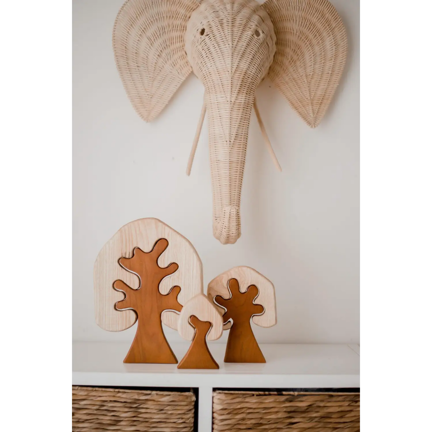 Woven elephant head wall decoration with large ears and trunk.
