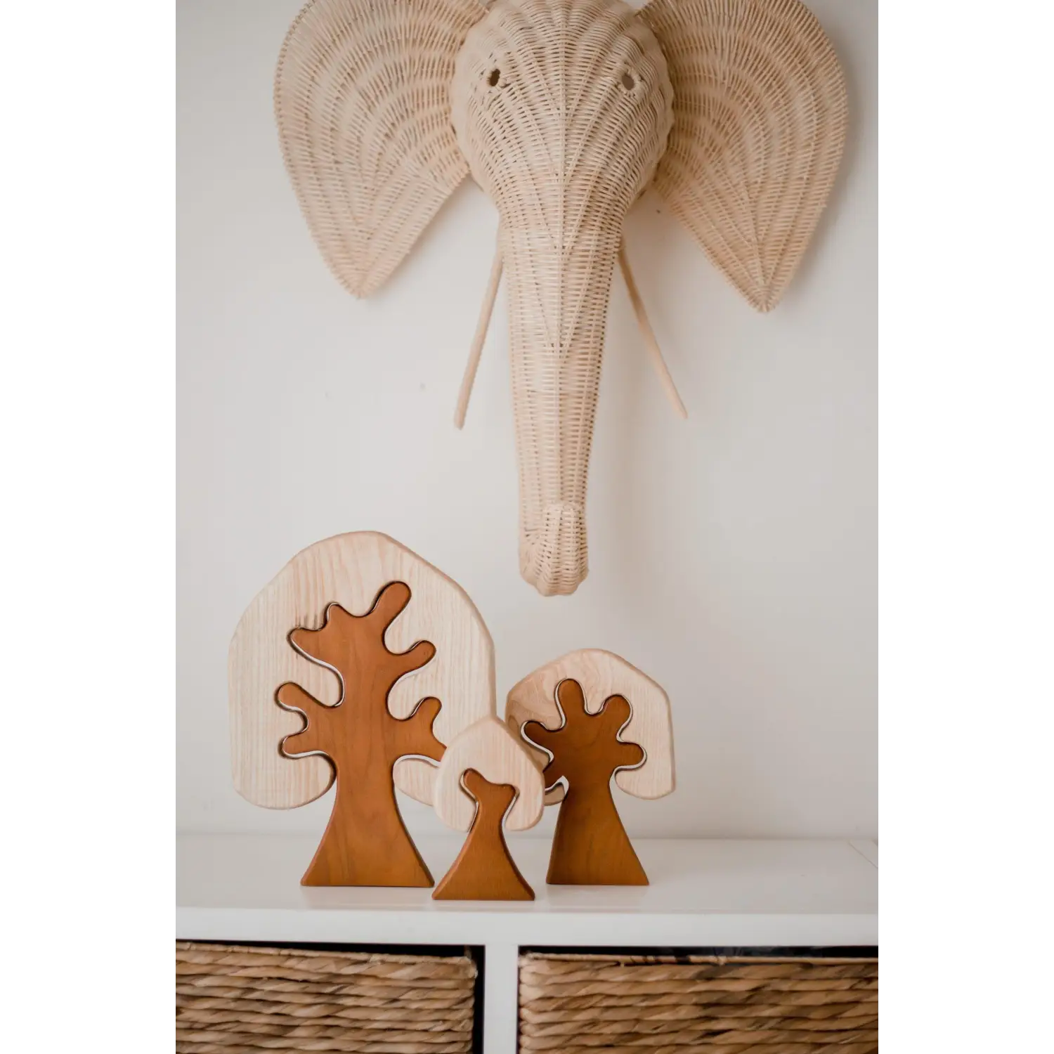 Woven elephant head wall decoration with large ears and trunk.