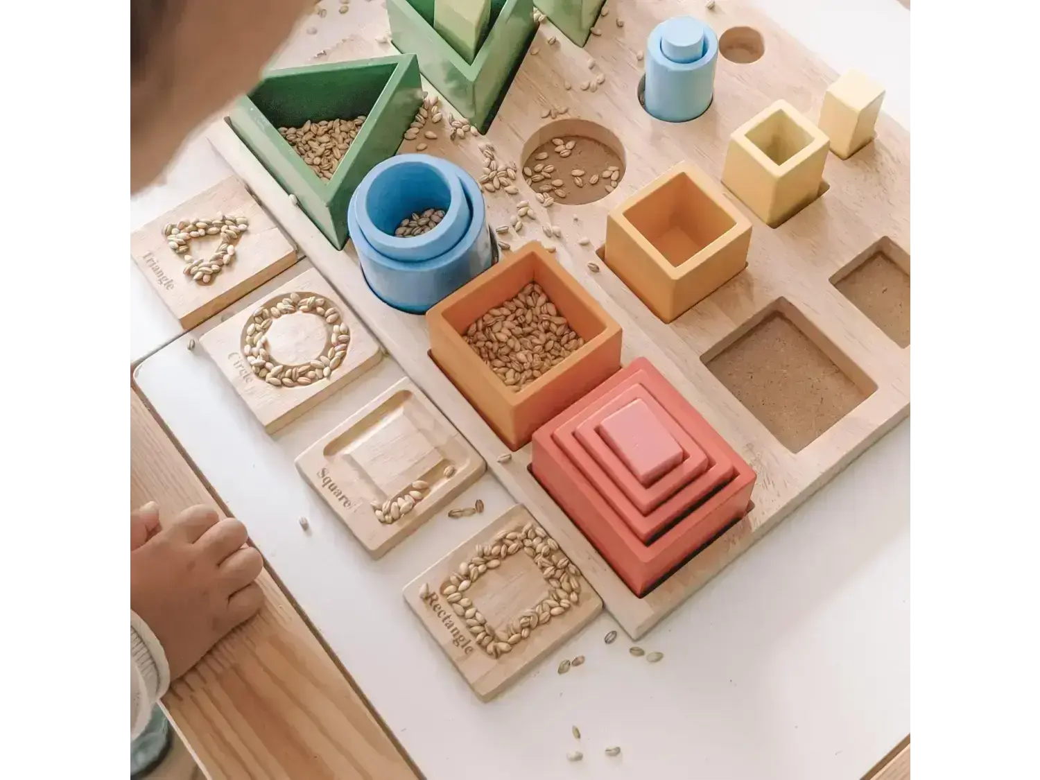 Montessori-style educational toy set with various geometric shapes and containers.