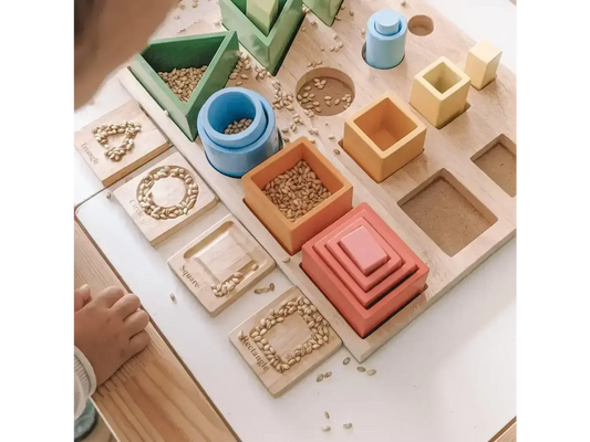 Montessori-style educational toy set with various geometric shapes and containers.