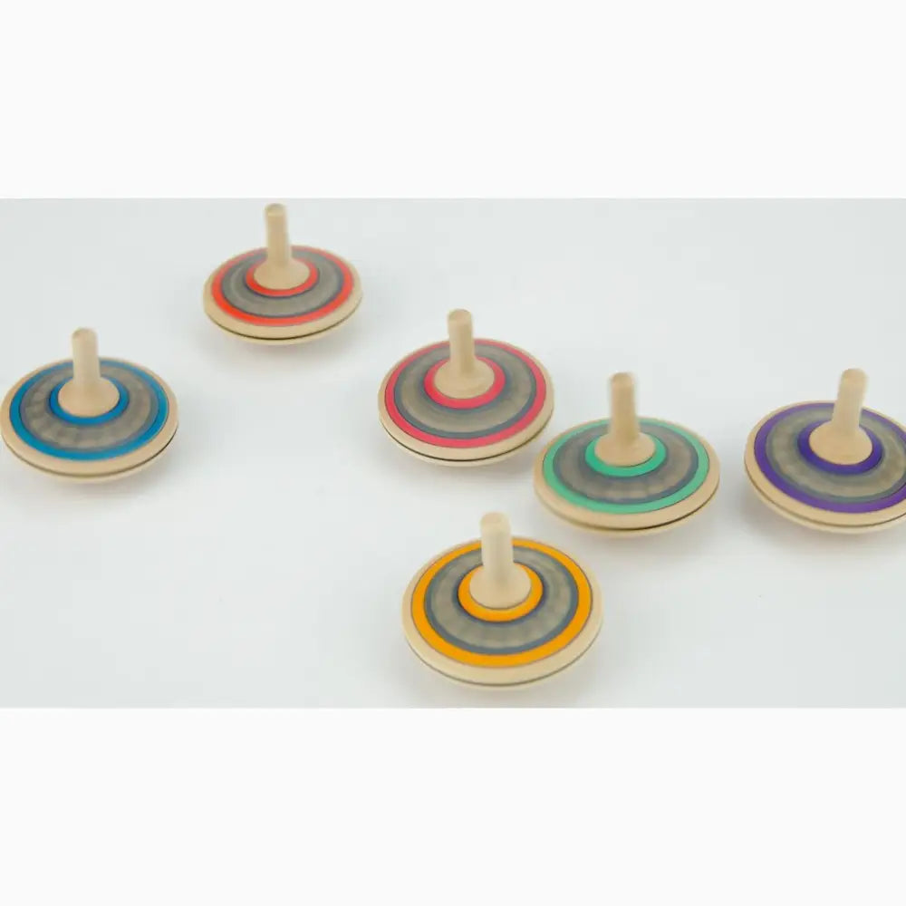 Colorful wooden spinning tops arranged in a row.