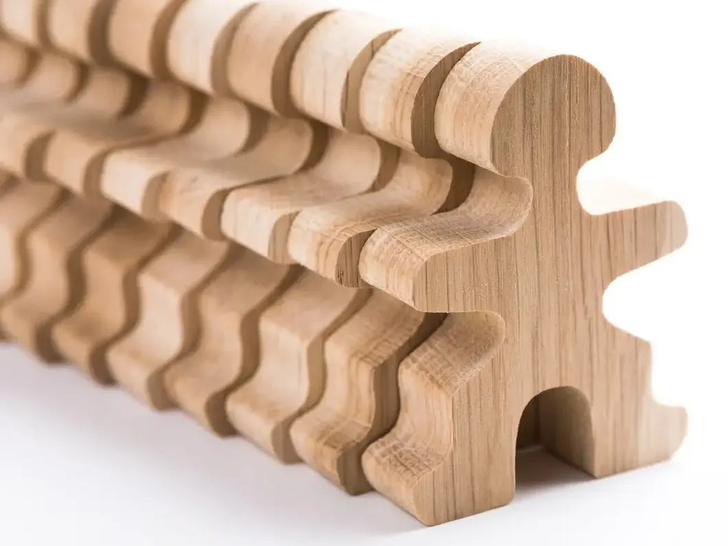 Wooden puzzle piece with a wavy, ridged surface along its length.