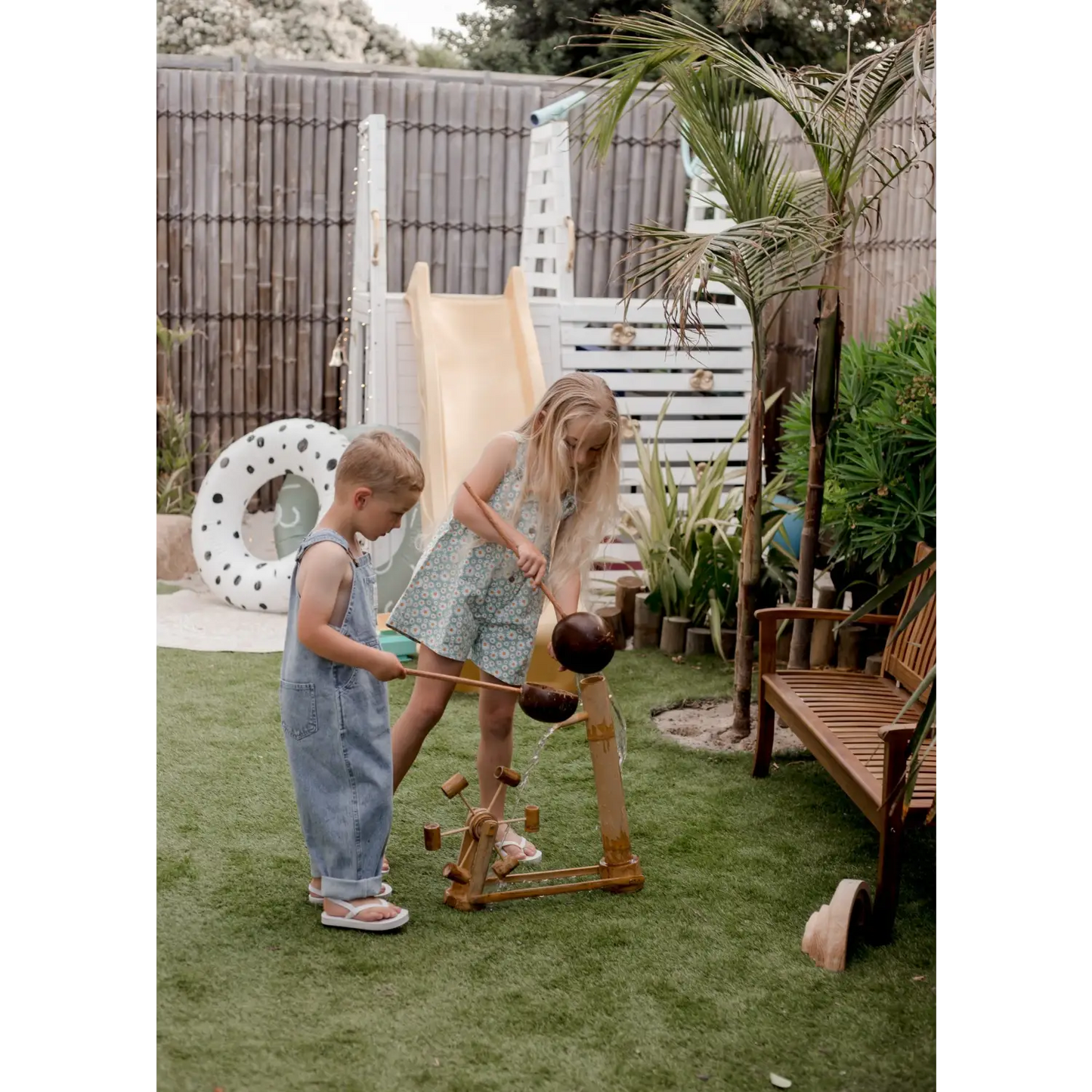 Children playing with a wooden toy.
