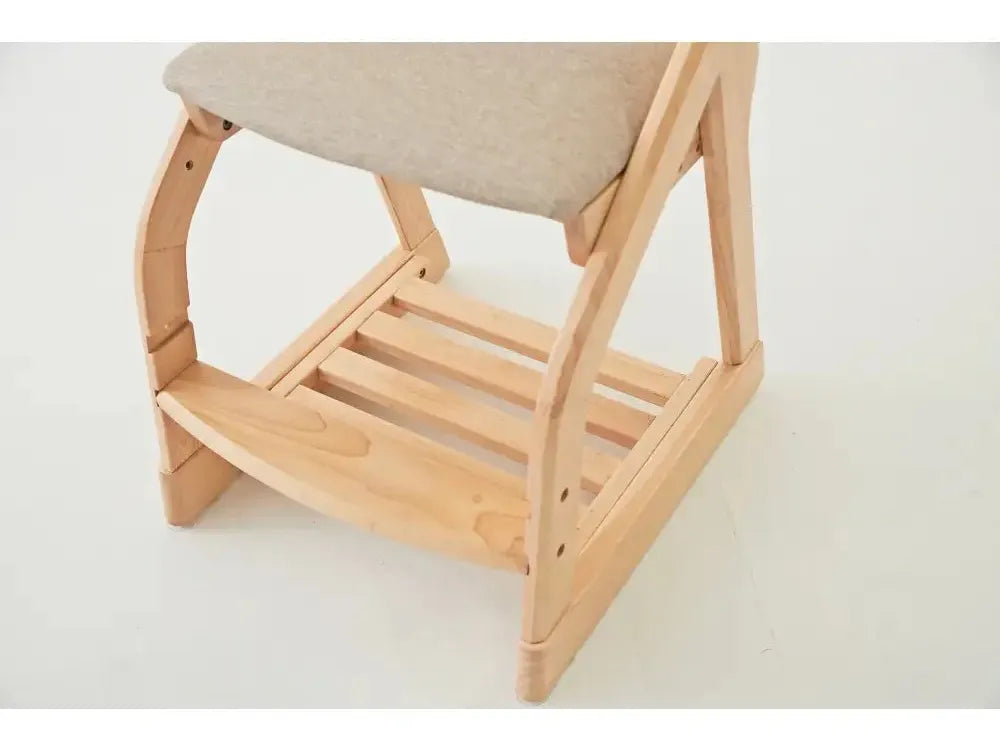 Wooden chair with a light-colored cushioned seat and slatted lower shelf.