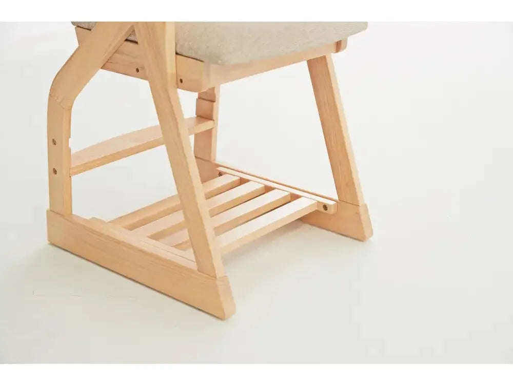 Wooden desk or table with angled legs and a slatted lower shelf.