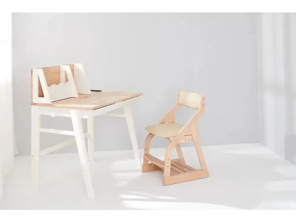 Minimalist wooden desk with an attached backboard and a matching chair.