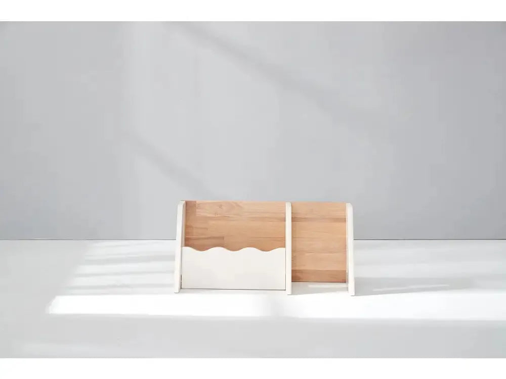 Wooden desk organizer or file holder with a wavy cutout design.
