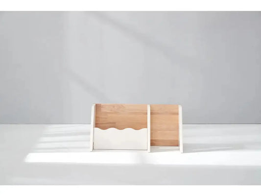Wooden desk organizer or file holder with a wavy cutout design.