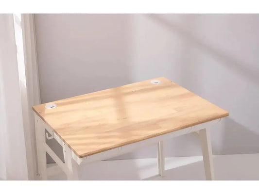 Simple wooden desk or table with light-colored top and white legs.