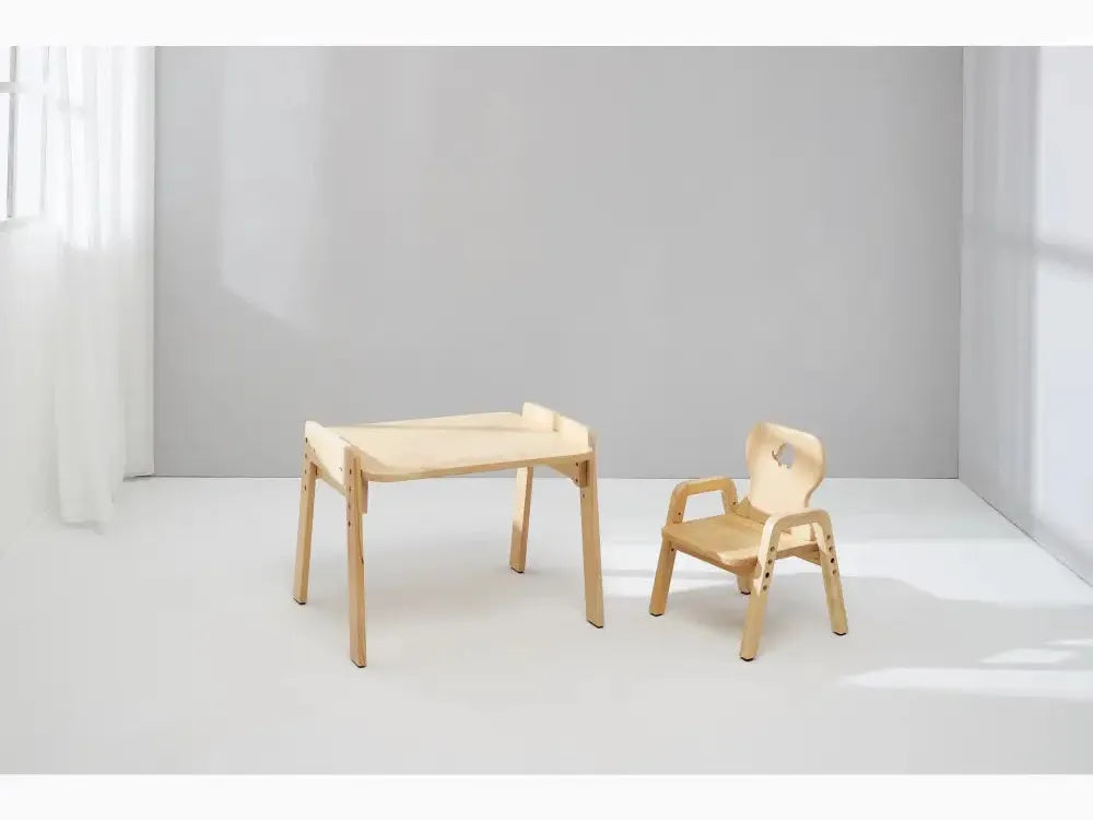 Wooden children’s desk and chair set with minimalist design.