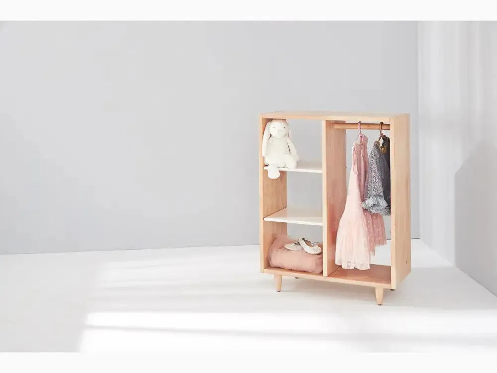 Wooden wardrobe with open shelves and hanging space for children’s clothes.