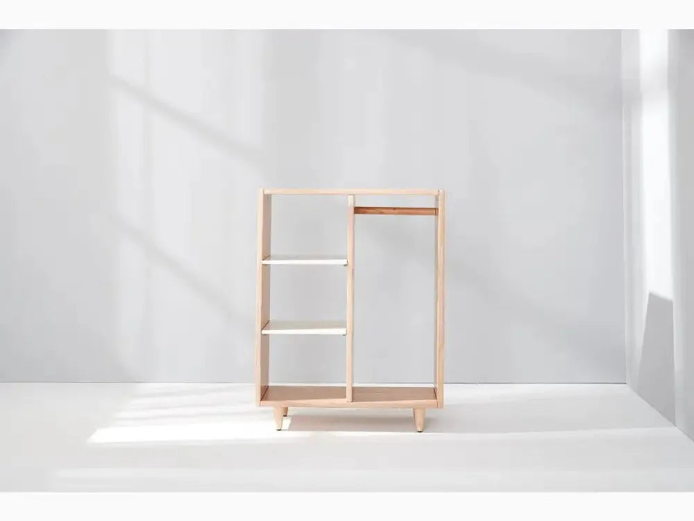Minimalist wooden shelving unit with open compartments and a clean, modern design.