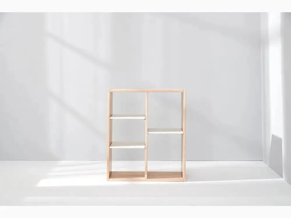 Wooden shelving unit with six compartments arranged in an asymmetrical grid pattern.
