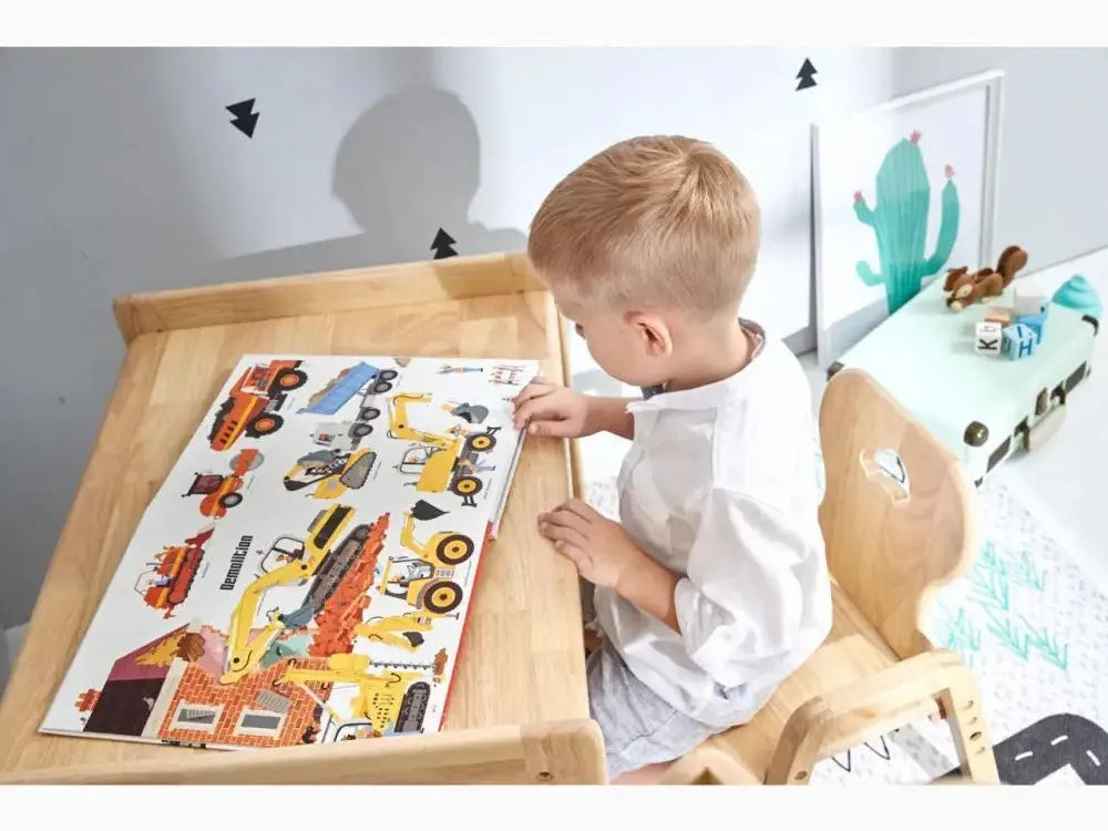 Young child working on a colorful vehicle-themed puzzle or activity board.