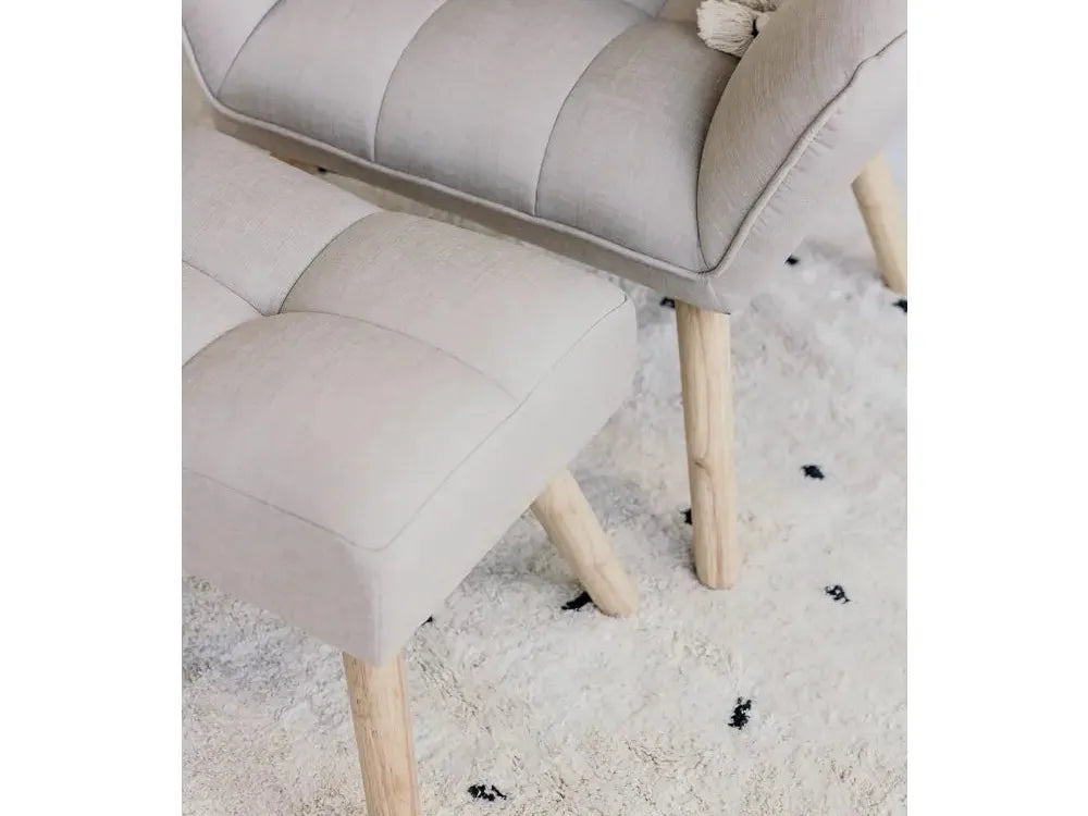 Upholstered footstool with wooden legs.