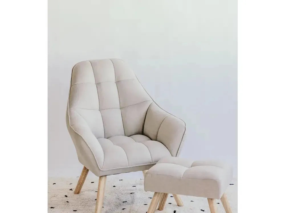 Beige upholstered armchair with matching footstool, both featuring wooden legs.