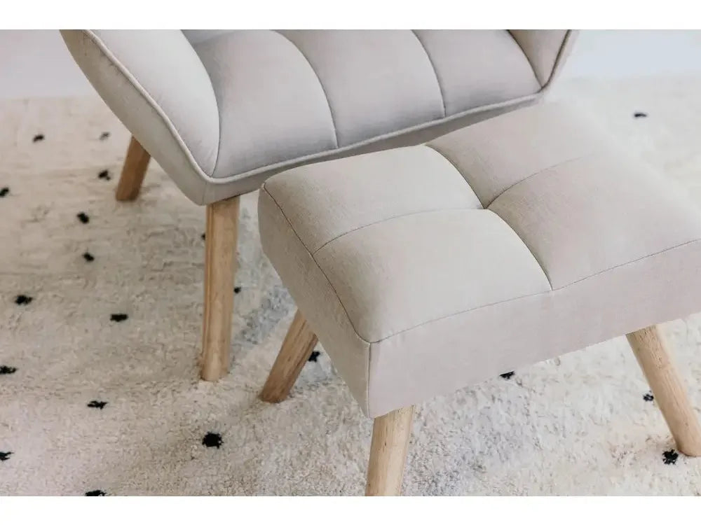 Upholstered chair with a matching footstool, both featuring light-colored fabric and wooden legs.