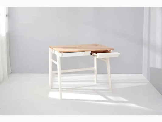 Minimalist desk with white legs and a wooden top featuring a built-in drawer.