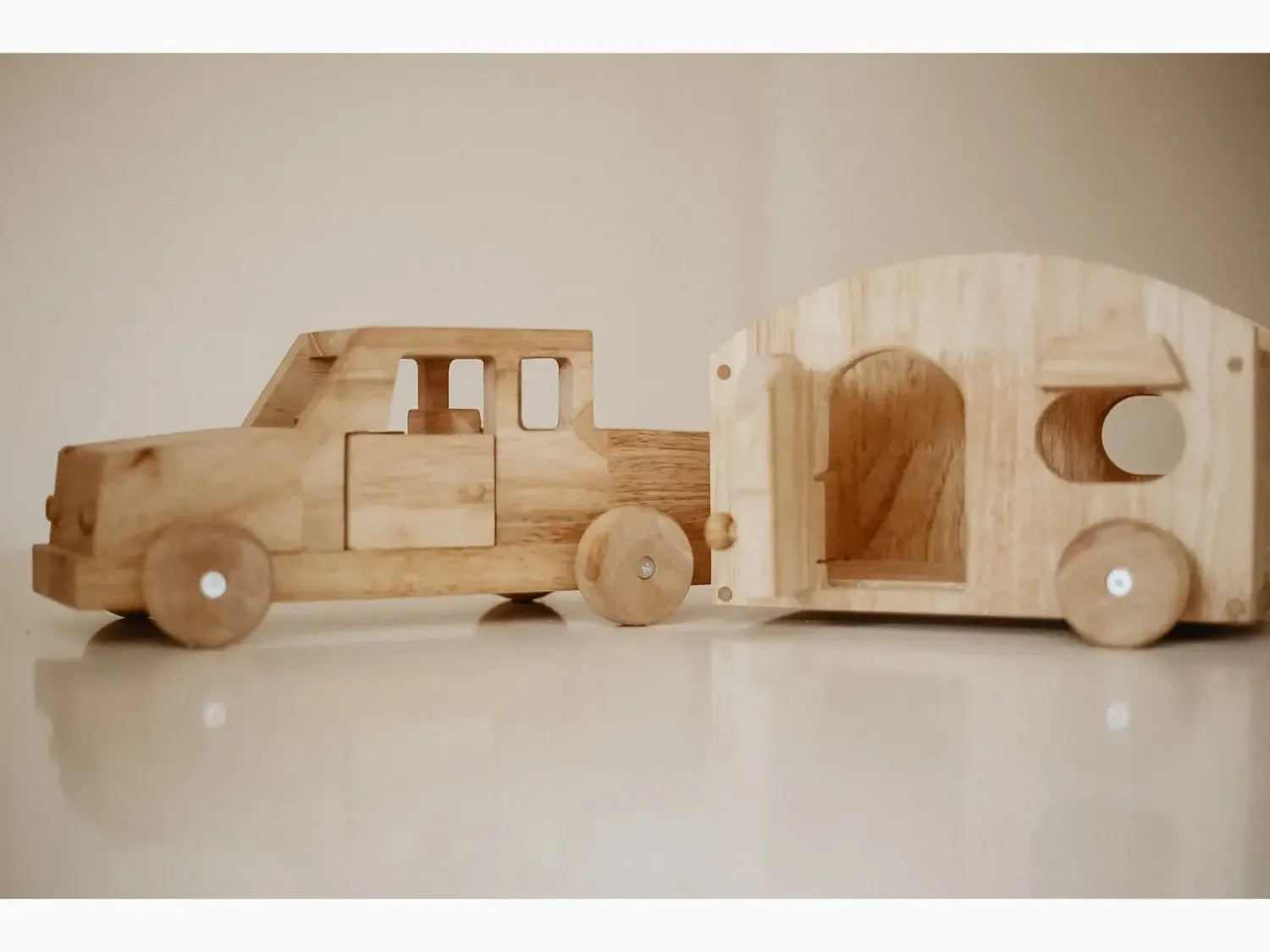 Wooden toy truck with camper.