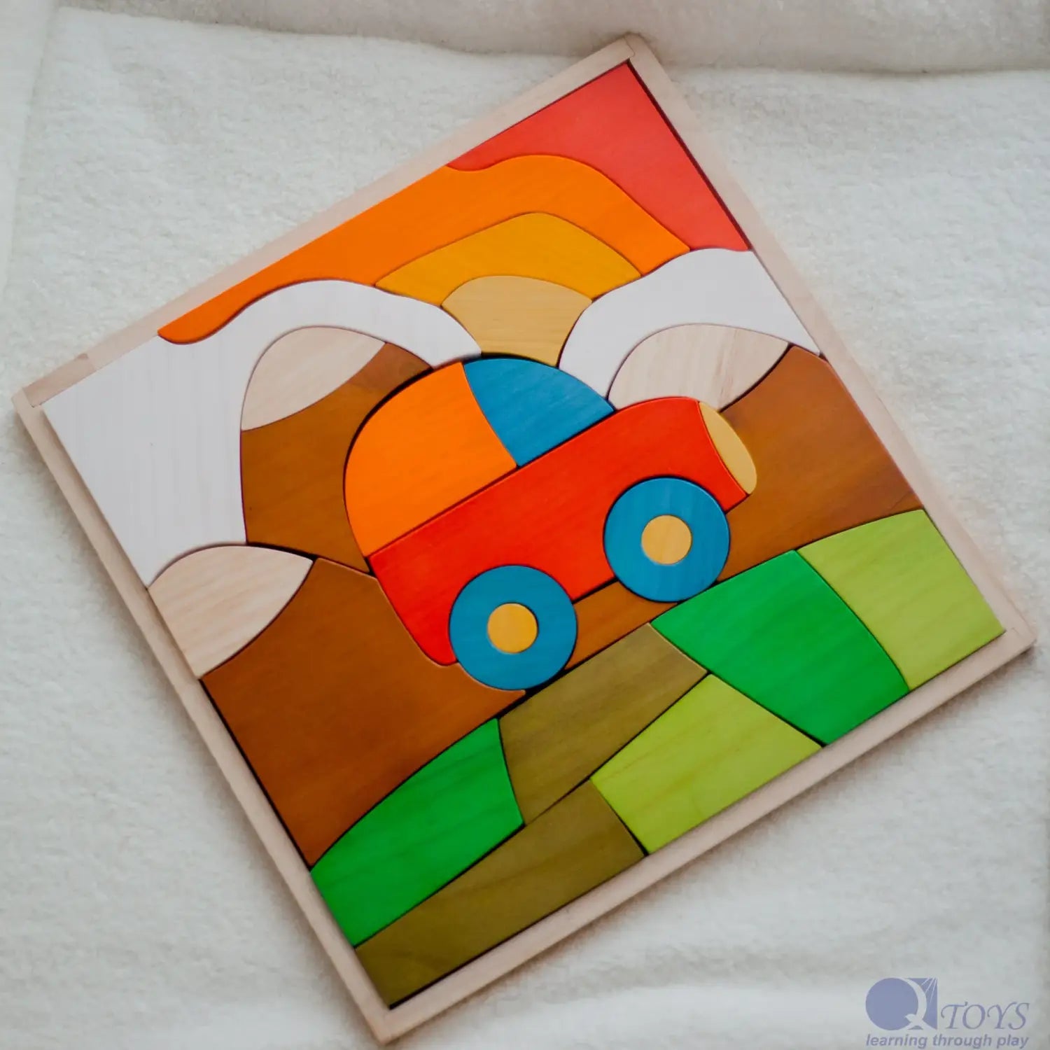 Colorful wooden puzzle depicting a stylized landscape with a car.