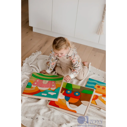 Toddler playing with colorful wooden puzzle pieces on a blanket.
