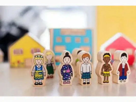 Wooden toy figures representing diverse children from different cultures.