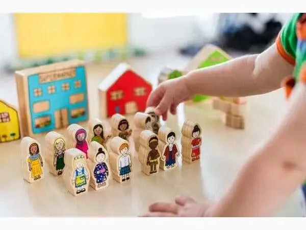 Wooden toy set featuring diverse miniature people figures and colorful house-shaped blocks.
