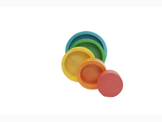 Set of colorful nested circular plates or discs in rainbow hues.