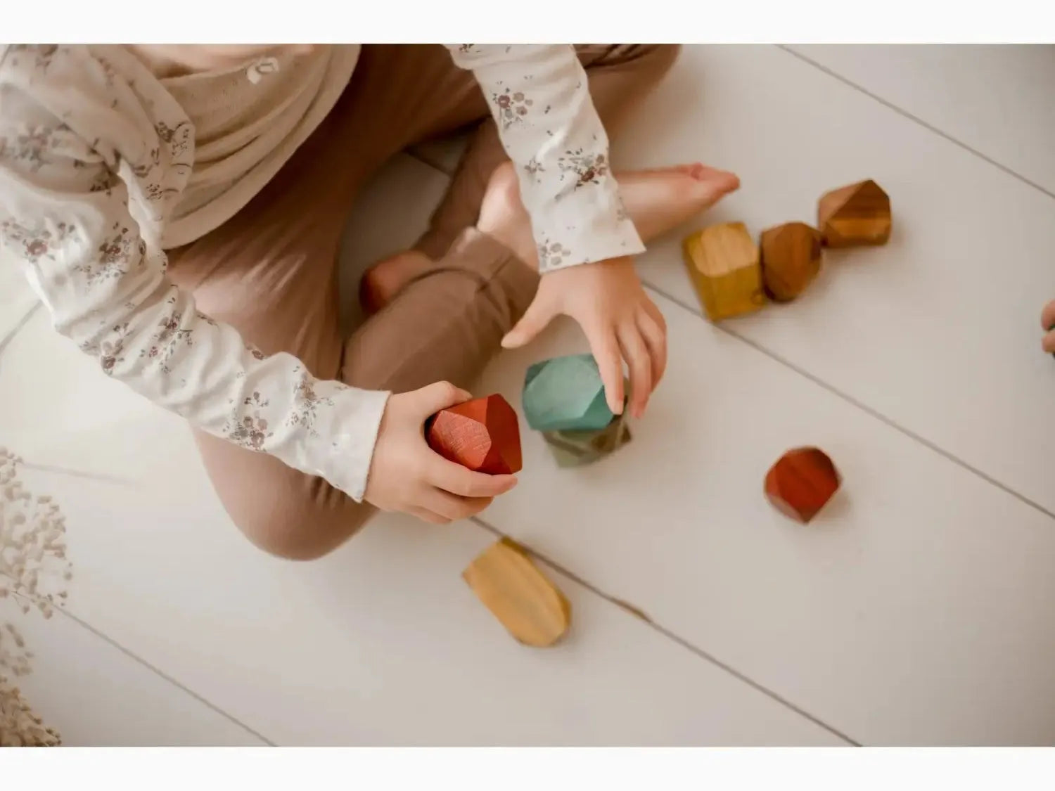 Wooden or silicone toy blocks in various shapes and colors.