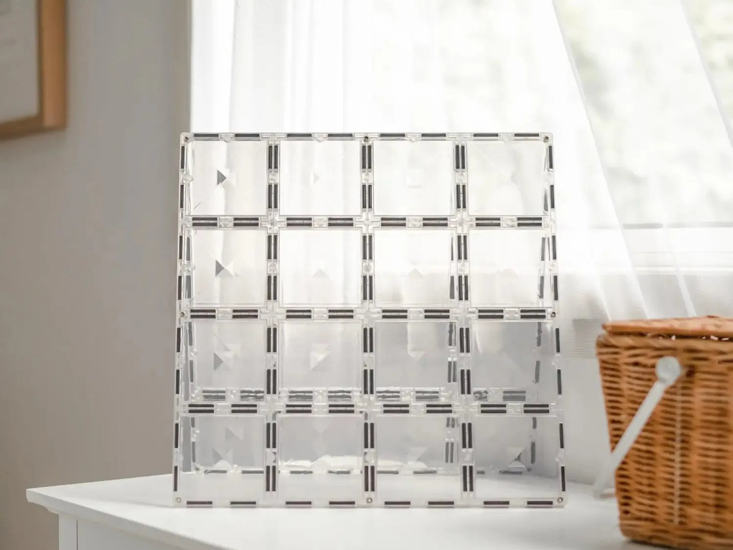 Clear acrylic organizer with multiple compartments arranged in a grid pattern.