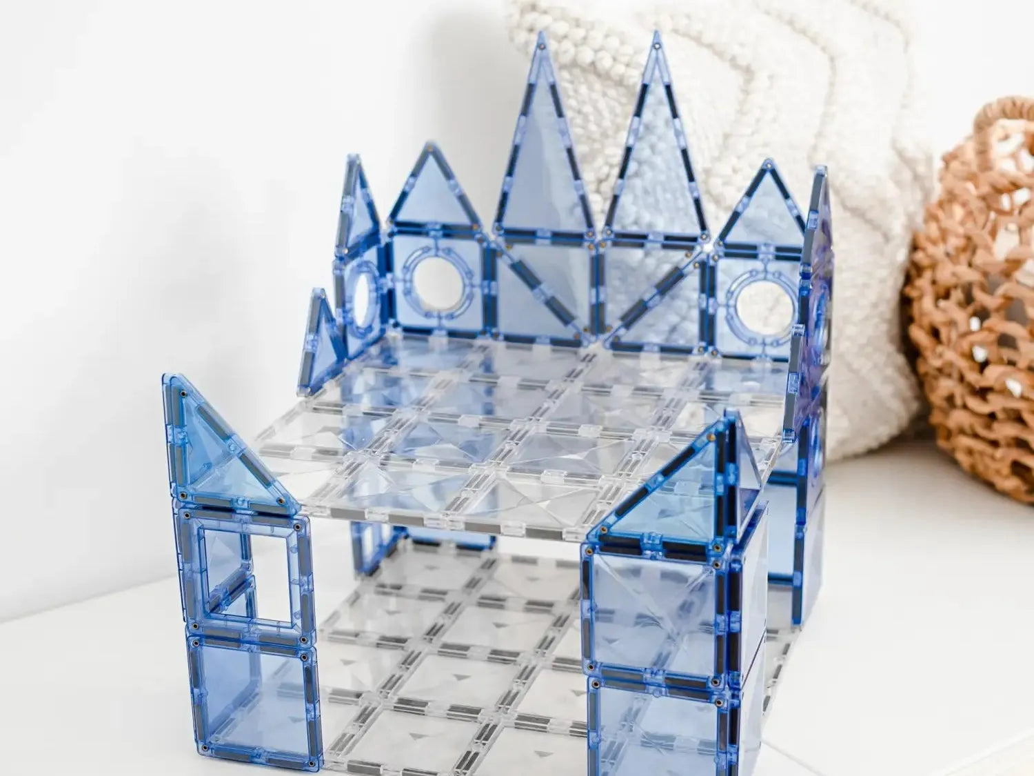 Blue translucent building-block structure resembling a miniature castle or fortress.