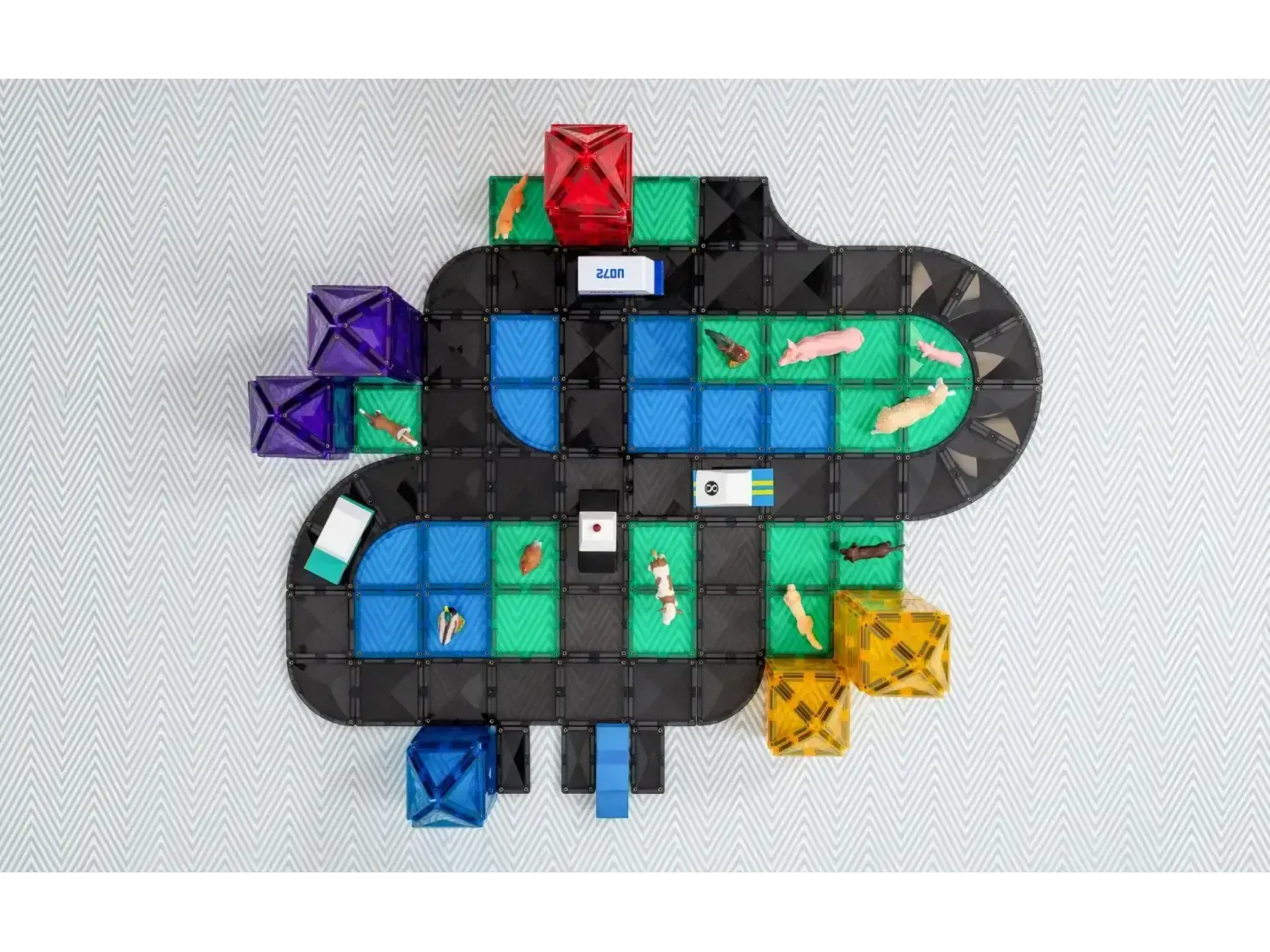 Colorful board game with a winding path made of various shaped tiles and pieces.