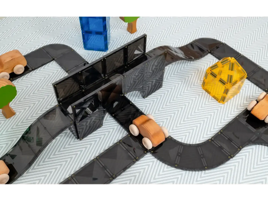 Toy road or racetrack with colorful vehicles and a bridge.