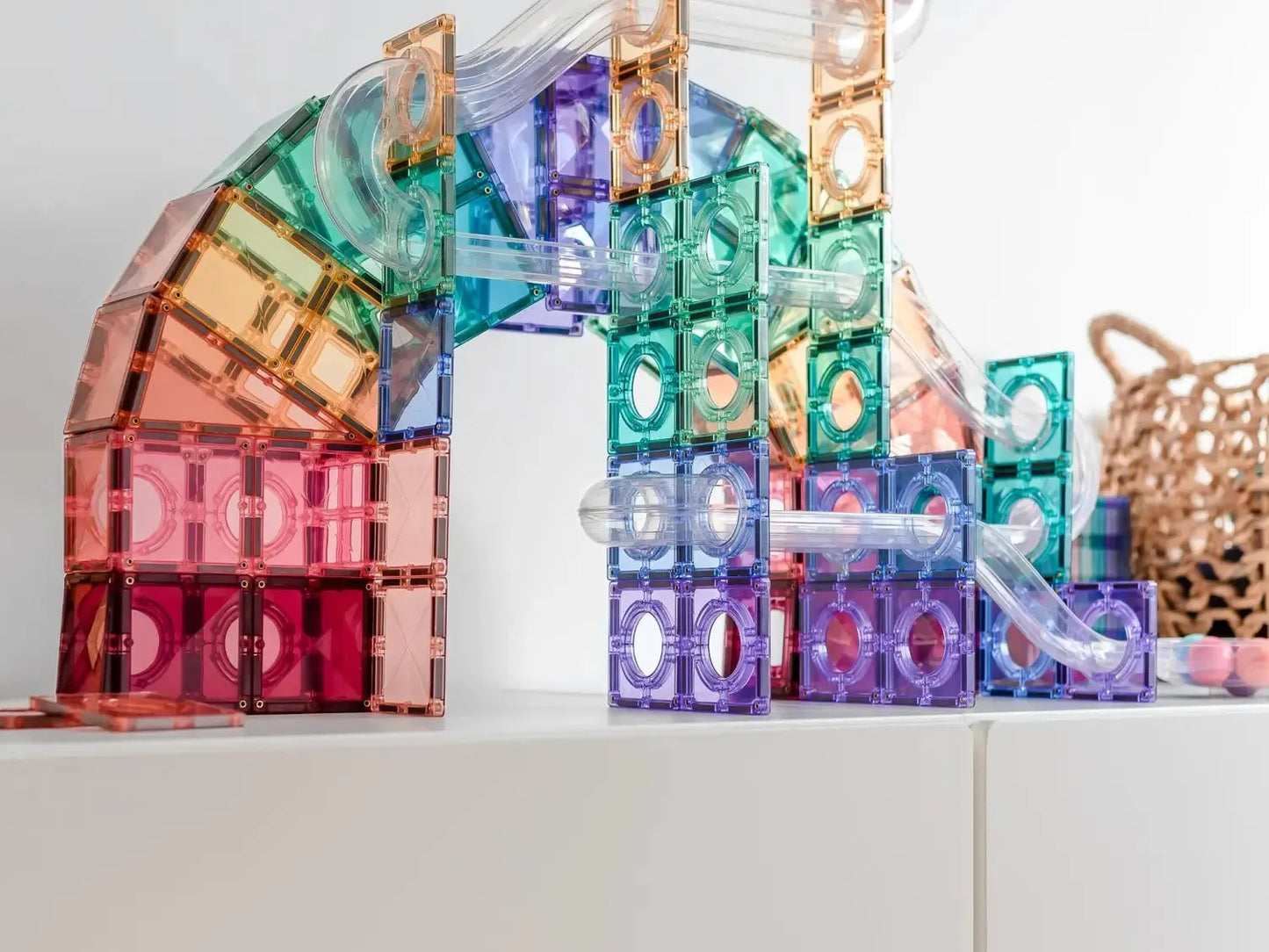 Colorful magnetic building tiles arranged in an abstract architectural structure.
