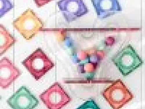 Colorful array of condom packets arranged in a decorative pattern.