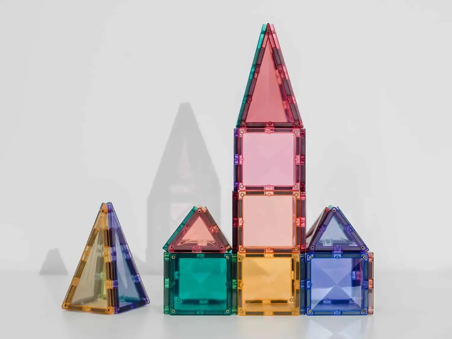 Colorful translucent geometric shapes resembling building blocks or a simplified toy house structure.