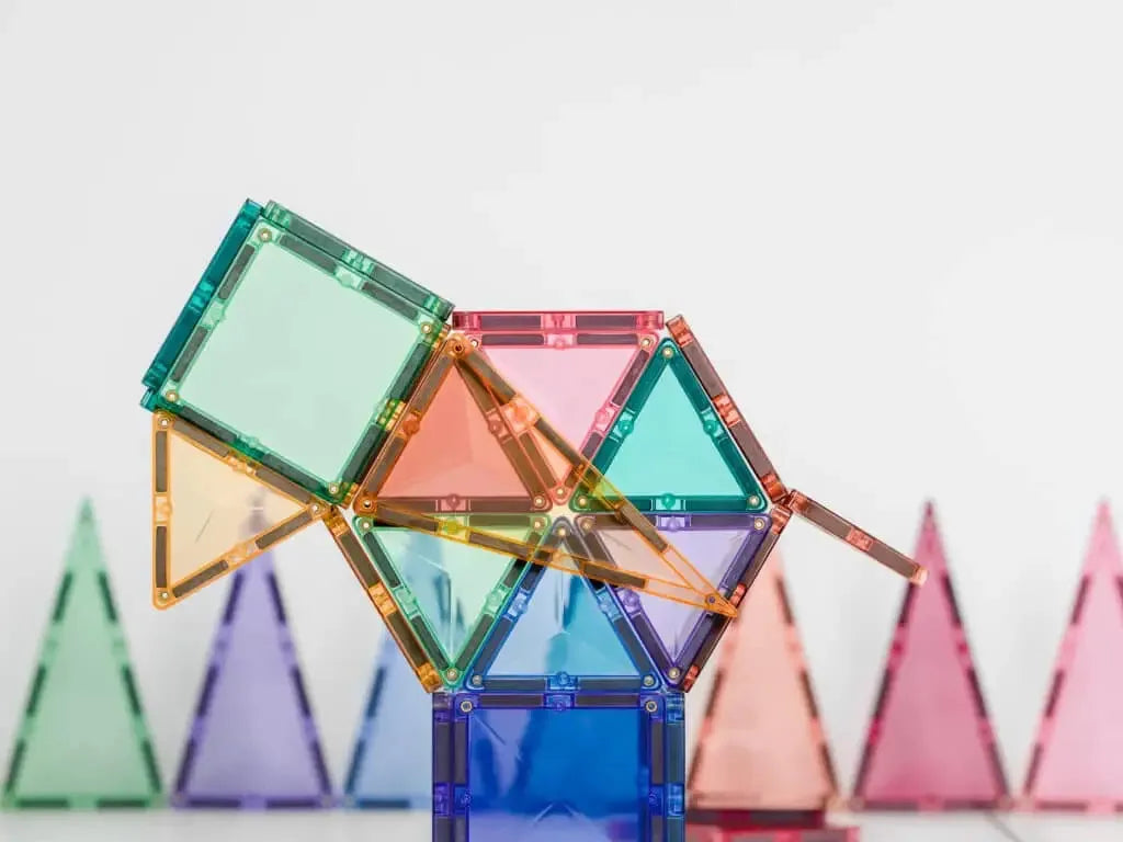 Colorful magnetic building tiles assembled into a geometric structure.