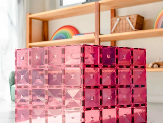 Pink translucent cube-shaped structure made of interconnected smaller cubes.