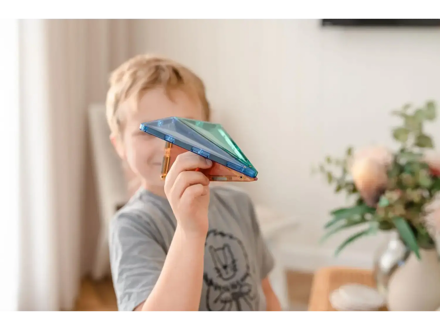 Paper airplane held by a child’s hand.