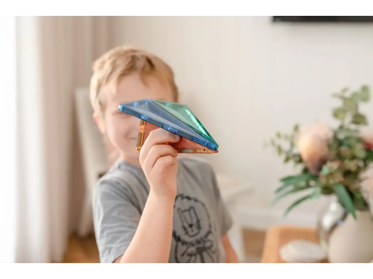 Paper airplane held by a child’s hand.