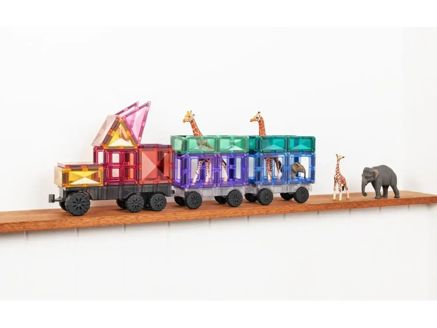Colorful toy train with animal-themed cars carrying a giraffe and elephant figurine.