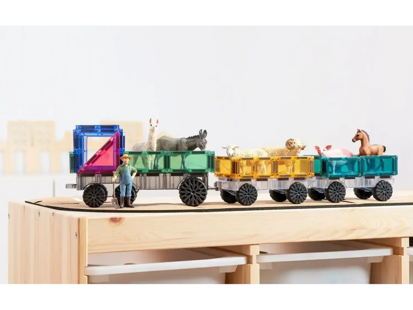 Colorful wooden toy train with animal figures riding in its carriages.