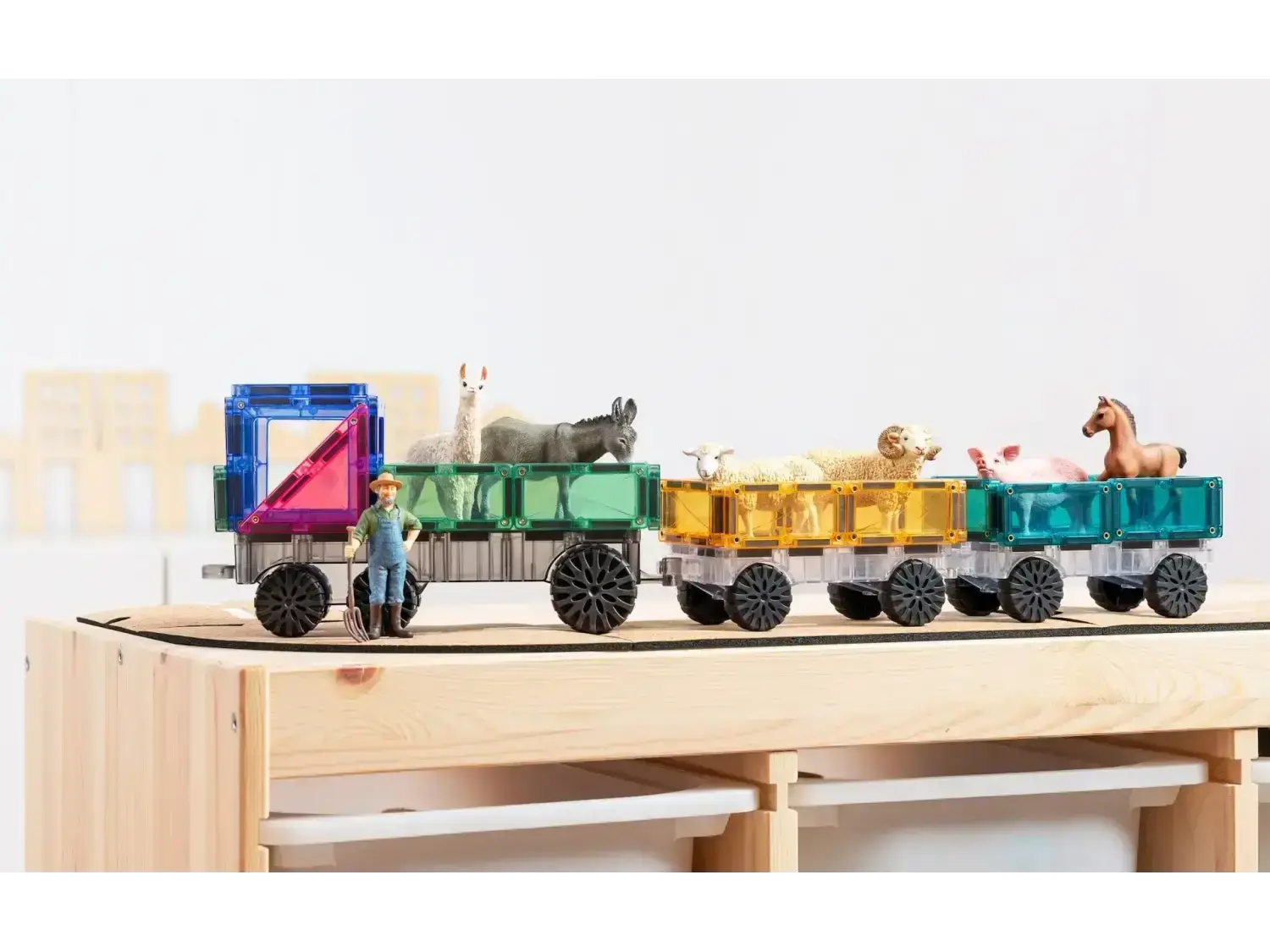 Colorful wooden toy train with animal figures riding in its carriages.