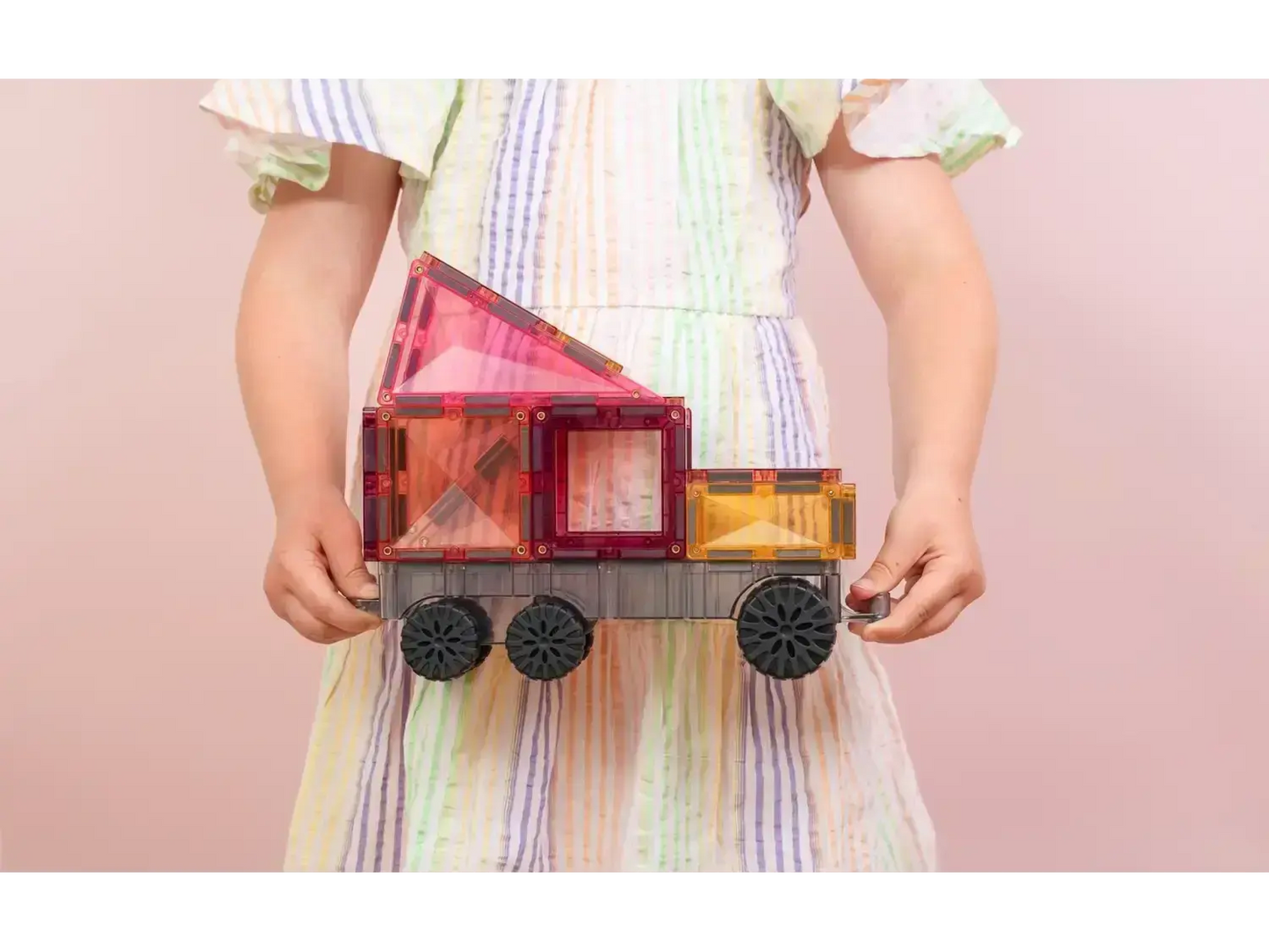 Colorful wooden toy train with geometric shapes forming the carriages.