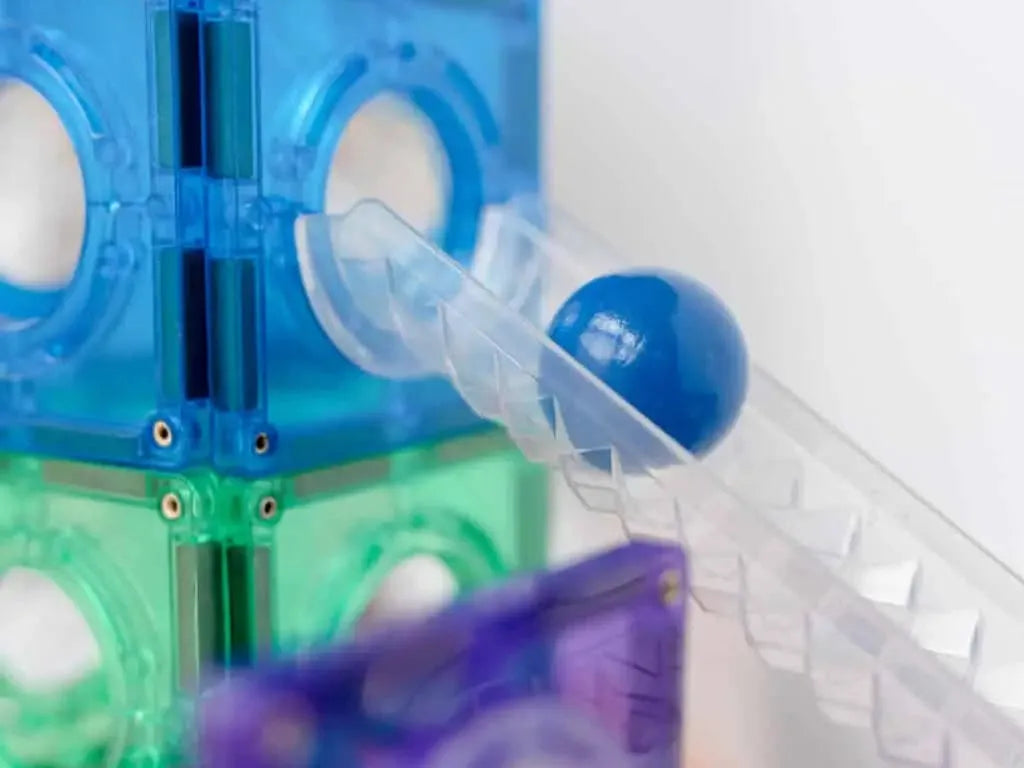 Colorful plastic construction toy with transparent cubes and a marble run component.