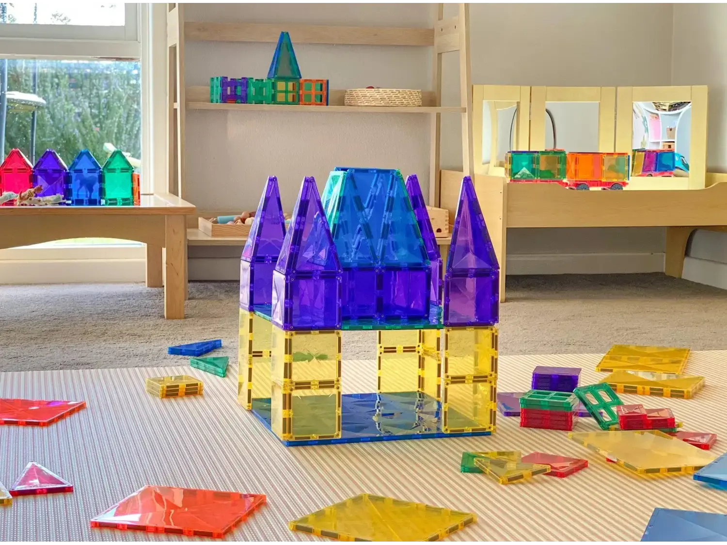 Colorful plastic building blocks assembled into a castle-like structure with purple towers.