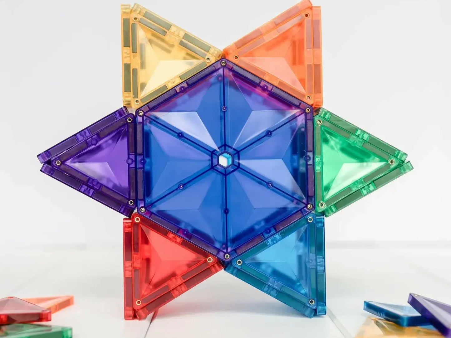 Colorful star-shaped geometric construction made of translucent plastic triangular pieces.