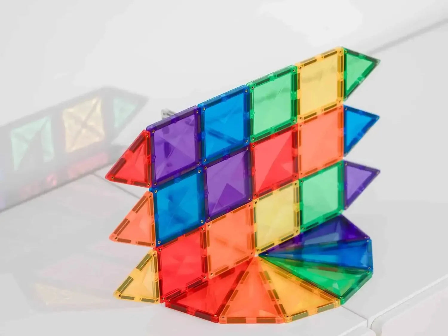 Colorful geometric construction toy made of translucent plastic triangular pieces.